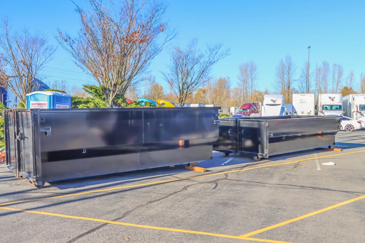 Professional dumpster rental service with roll-off container on residential driveway in West Carrollton